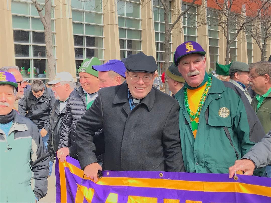 Cathedral Latin alumni marching with banner